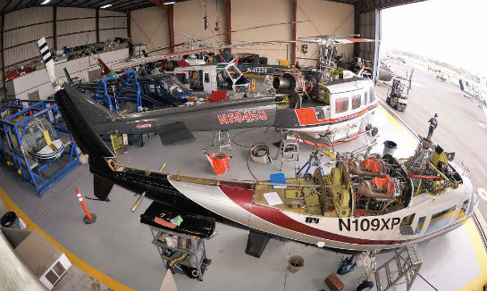 A typical scene at RSI: a hangar full of helicopters in different stages of maintenance and repair.