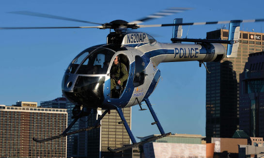 With downtown Louisville behind it, the MD 520N climbs out after a landing on an Ohio River island.