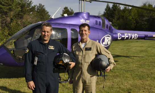 Bell Helicopter test pilot Yann Lavallee and flight test engineer Bernhard Willenbrink pose with the third prototype Bell 505 JetRanger X shortly after flying in from the helicopter manufacturer's Canadian factory in Mirabel, Quebec. 