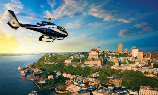 A GoHelico Airbus Helicopters EC130 B4 gives a group of tourists a spectacular vantage point to take in the Château Frontenac and Old Quebec — a UNESCO World Heritage Site. Capitale Hélicoptère Photo