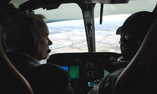 Gary Krebs, left, chief test pilot for Airbus Helicopters Canada, guides an Airbus H130 over the area surrounding Region of Waterloo International Airport. Ben Forrest Photo