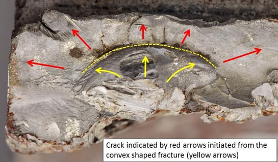 A close-up view of the fracture surface. Multiple cracks can be seen propagating from a major crack around the convex fracture surface. QinetiQ Photo