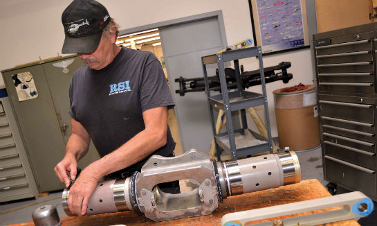 RSI mechanics work on a Bell UH-1 rotorhead in the RSI overhaul shop.