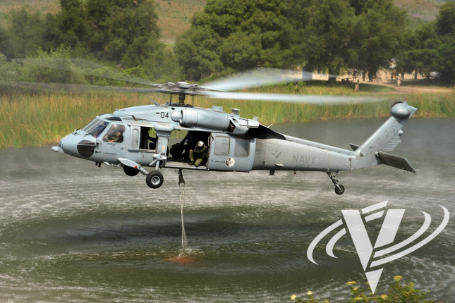 An MH-60S picks up another load of water during a demonstration earlier this year at a lake in Camp Pendleton.