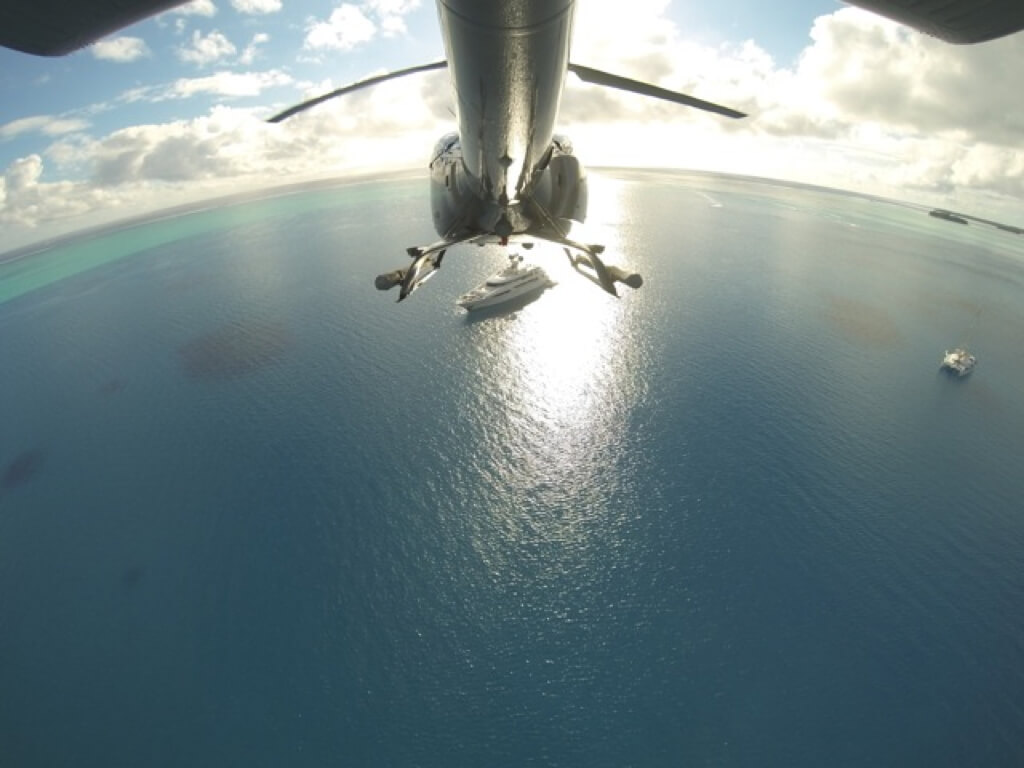 An EC130 B4 and the yacht it calls home are in perfect alignment in this unique GoPro shot.