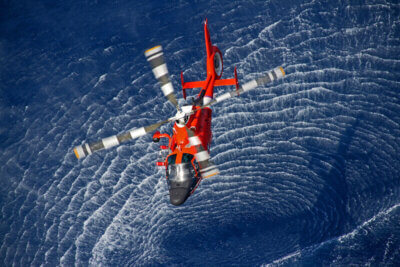 A Coast Guard MH-65C Dolphin from Air Station Borinquen hovers over Aguadilla Bay