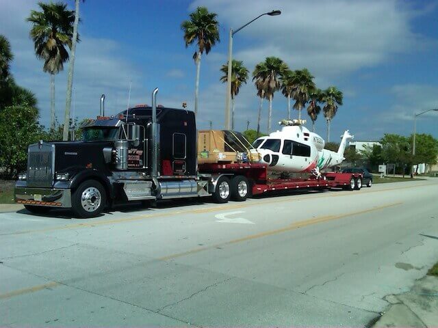 Photo of transport truck hauling a helicopter