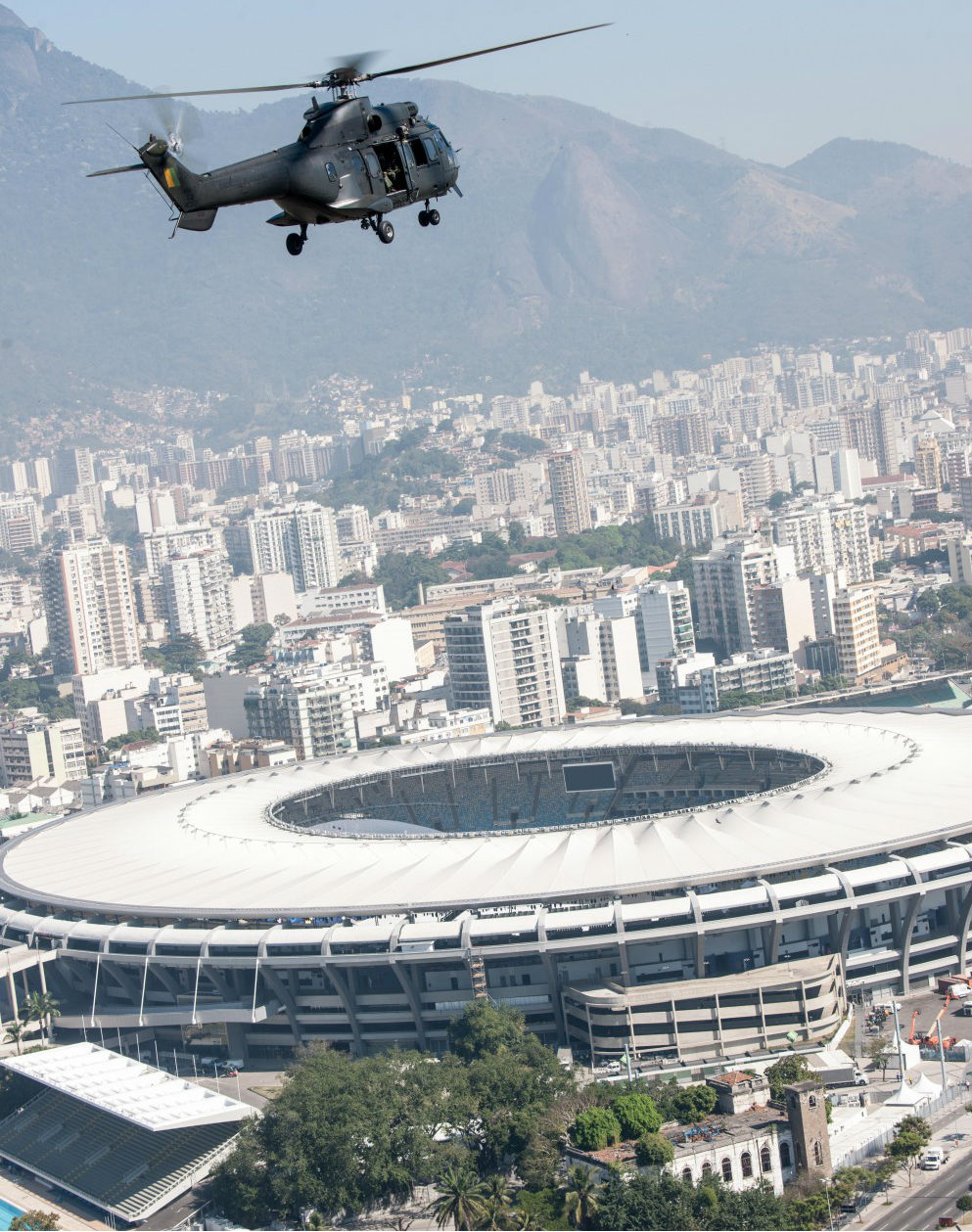 Helicopter flying with stadium in background.