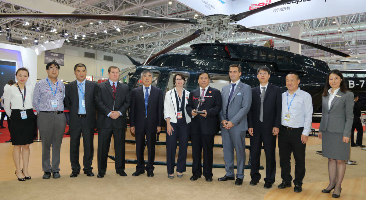 After the signing ceremony, Huaihe Sun (second from left), Xiaoning Yuan (fifth from left), Rachael Bedlington (sixth from left, Feng Jiang (seventh from left), and Patrick Moulay (eight from left) joined for a group photo. Bell Helicopter Photo