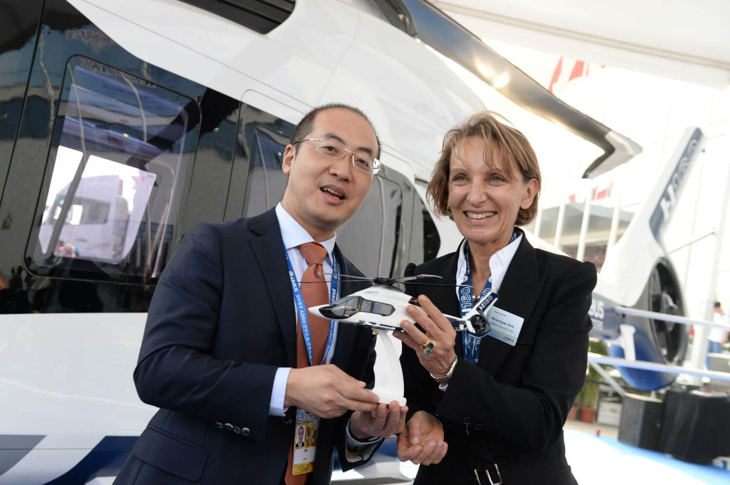 CMIG leasing and Airbus Helicopters representatives hold a model of the H160.
