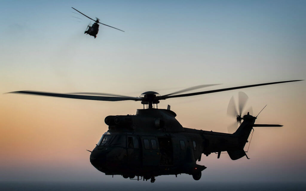 Two AS332 Super Pumas fly along the coast of Fuerteventura after a day of troop movements.