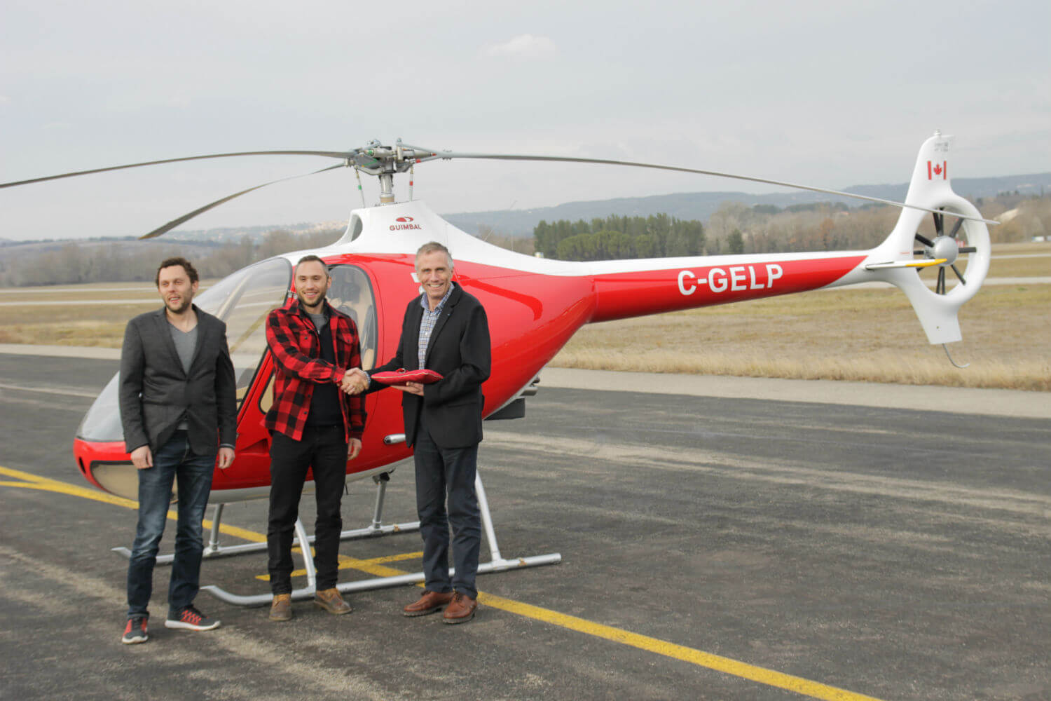 Mischa and Sancho Gelb, owners of British Columbia-based BC Helicopters, stand with Bruno Guimbal, president and CEO of Hélicoptères Guimbal. Hélicoptères Guimbal Photo