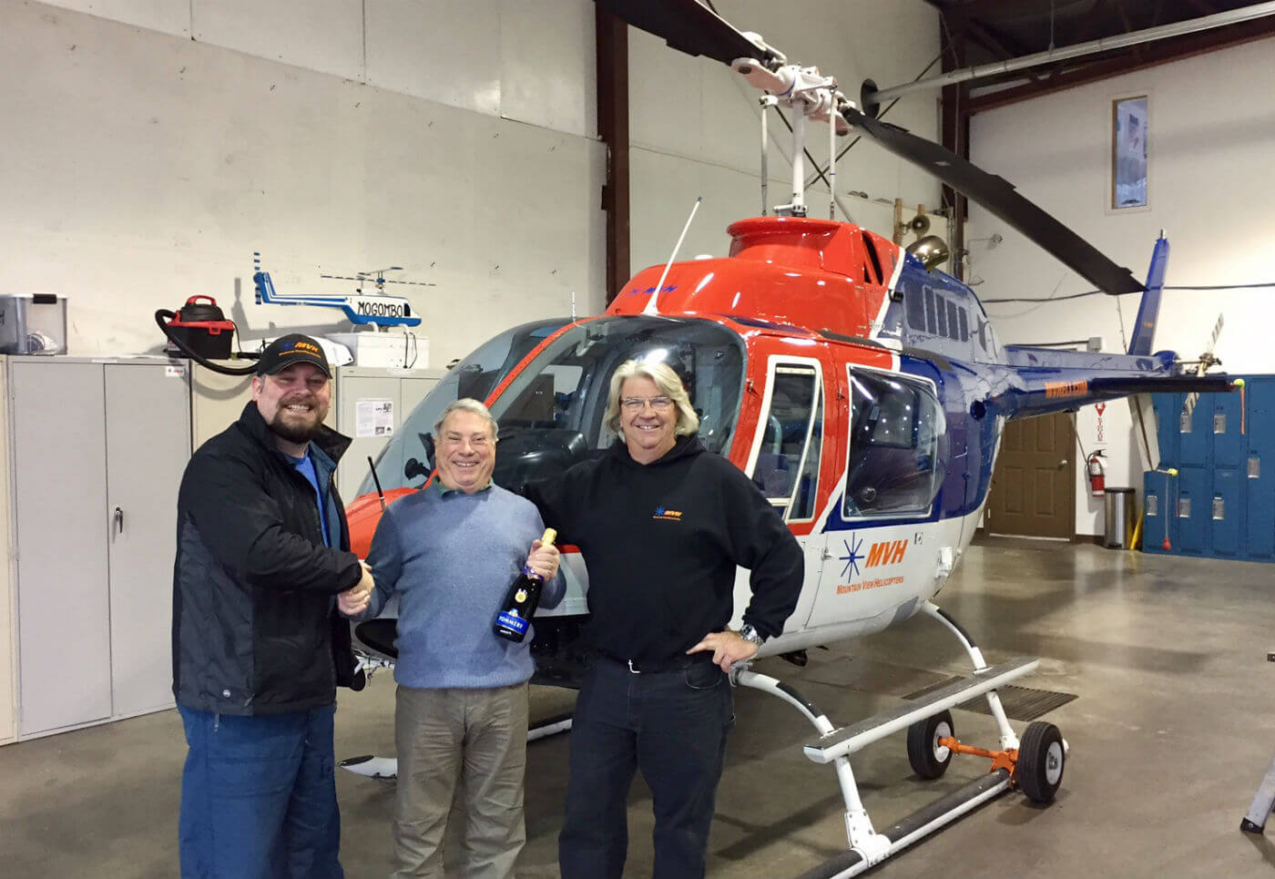 Richard Alzetta (middle) “semi-retired” in 2011, but still instructs part-time, flying about 300 to 400 hours a year. Here, he celebrates his landmark with Paul Bergeron (right), Mountain View Helicopters president. Mountain View Helicopters Photos
