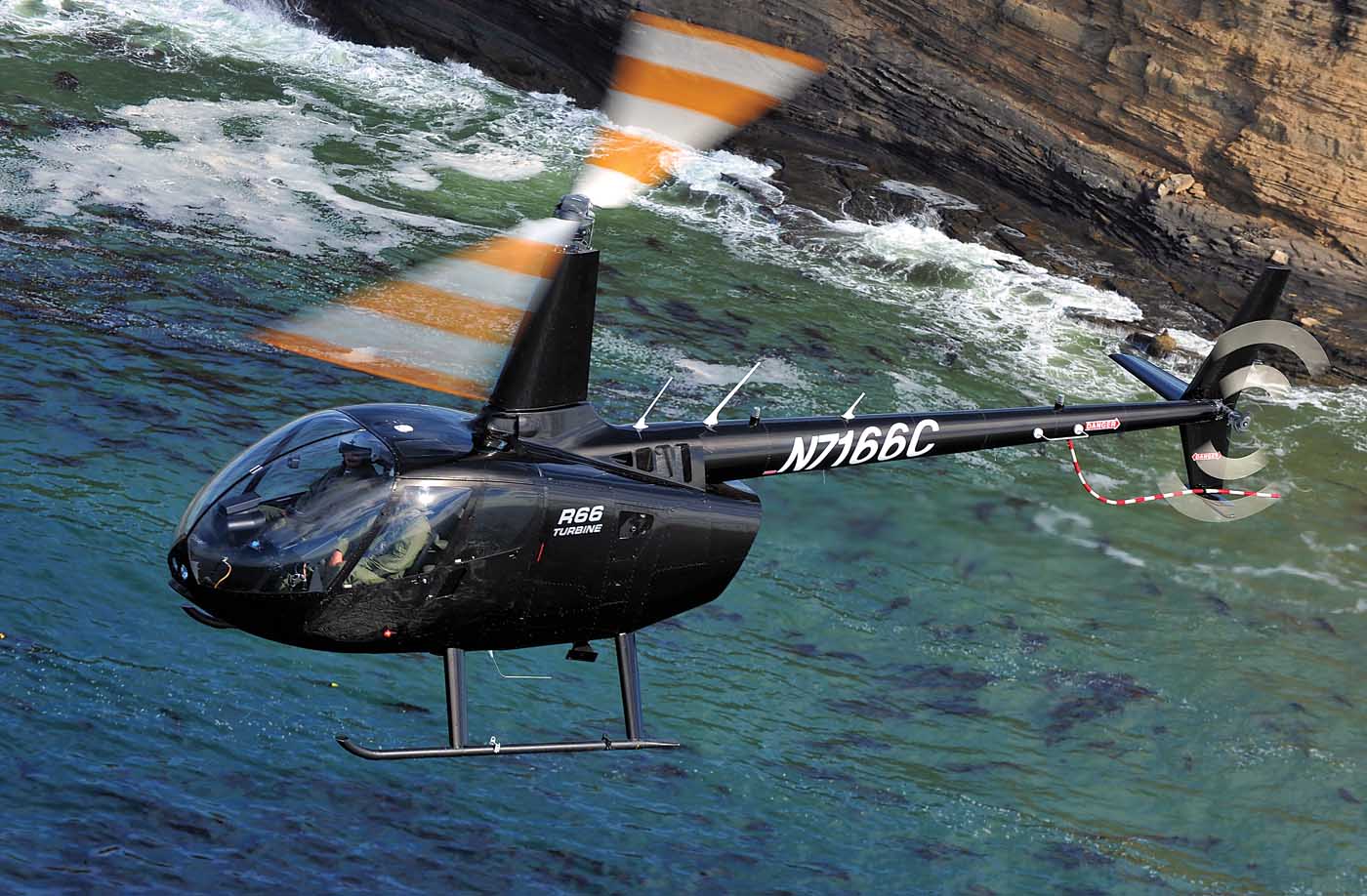 A Robinson R66 flies off the coast of California near the manufacturer’s plant in Torrance. Skip Robinson Photo