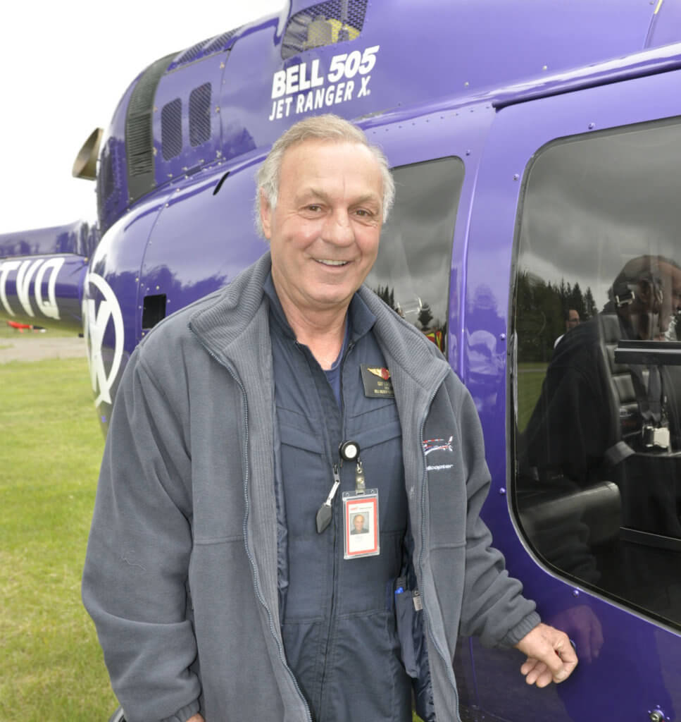 This year's celebratory helicopter pilot at the HeliClub fly-in was retired National Hockey League right-winger Guy Lafleur, wearing a Bell Helicopter pilot's identification badge.