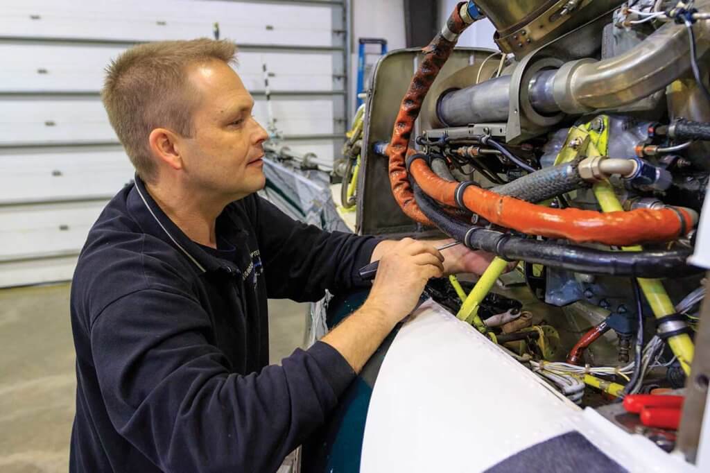 Shop foreman Ben Bruner completes an engine inspection.