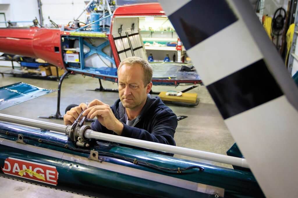 Technician Chris Samus installs a tail rotor drive shaft.