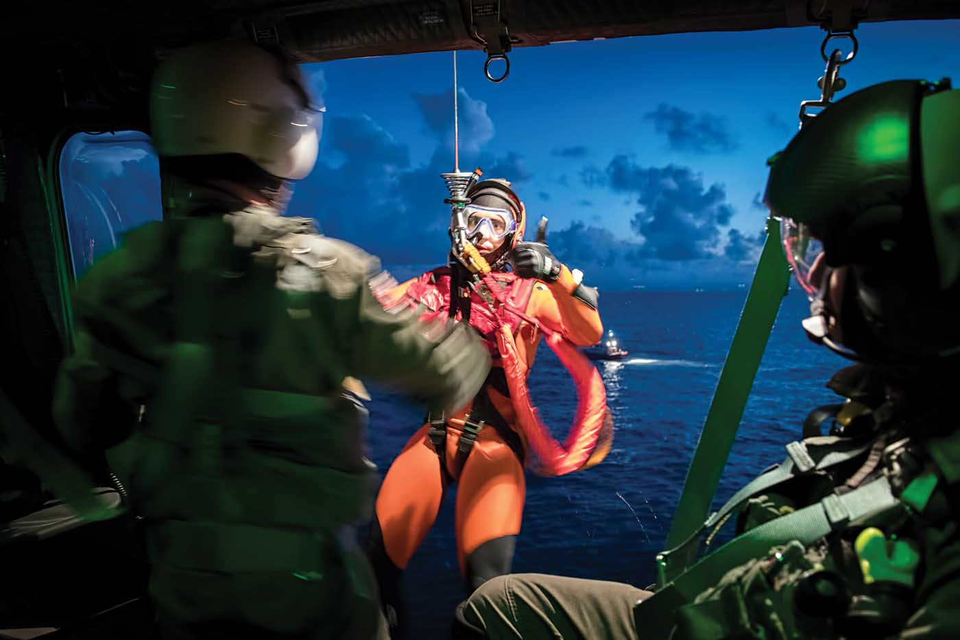 A rescue swimmer gives the thumbs up to the winch operator during a training exercise off the coast of Catania, Sicily, the home of Guardia Costiera’s 2° Nucleo Aereo.