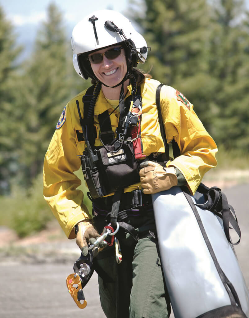 Lisa Hendy walks to the helibase for another rappel.