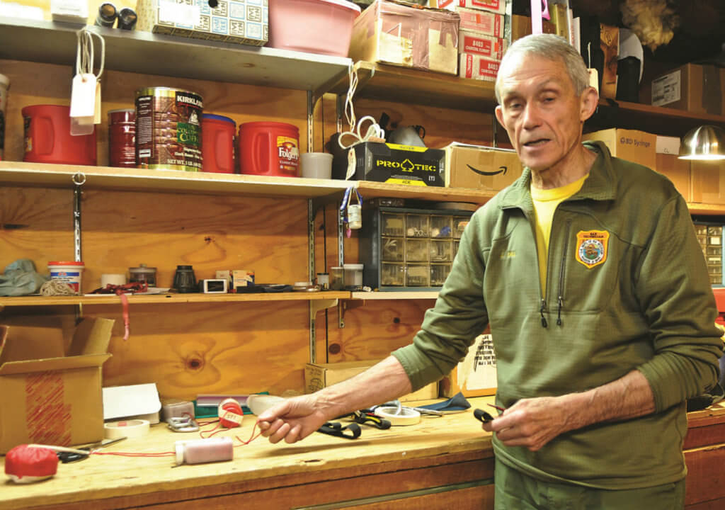John Dill explains the beanbag system he has developed over the past 30 years in his workshop in the SAR cache at Yosemite National Park.