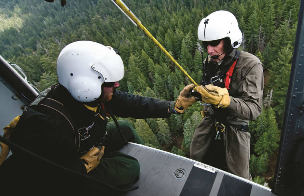 Ranger Jack Hoeflich is checked by Boots Davenport just prior to dropping down between the trees.