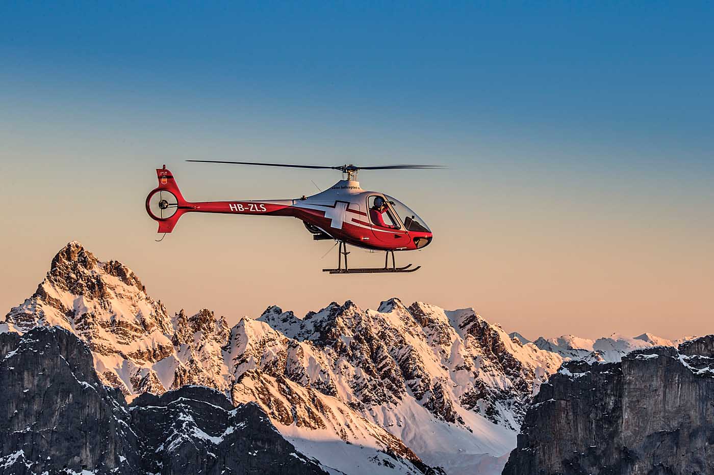 A Swiss Helicopter Guimbal Cabri G2 holds a hover in front of a typically-dramatic Swiss backdrop. The operator, formed from the amalgamation of six different companies in 2012, has become a major presence in the landlocked Central European country.