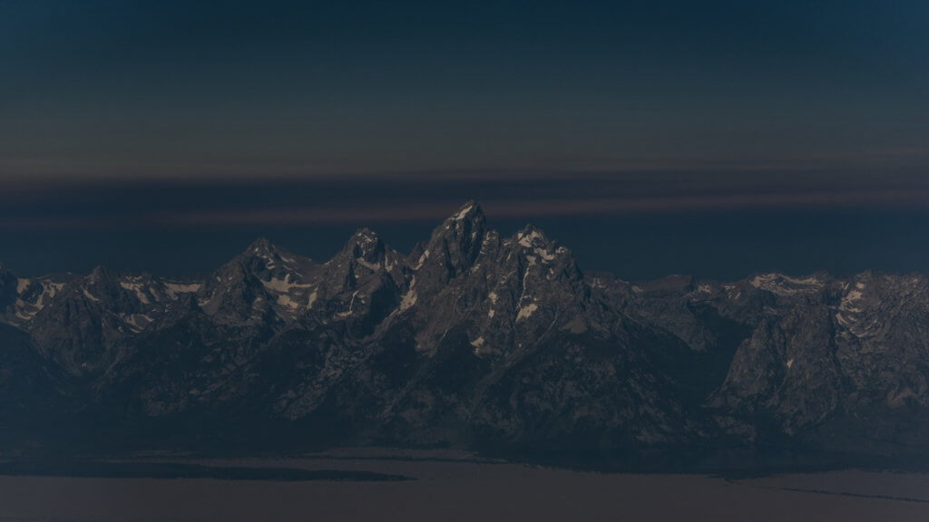 An aerial view of Wyoming's Teton Range as the solar eclipse approached totality. Lina Collado Photo / Instagram: @lina_collado