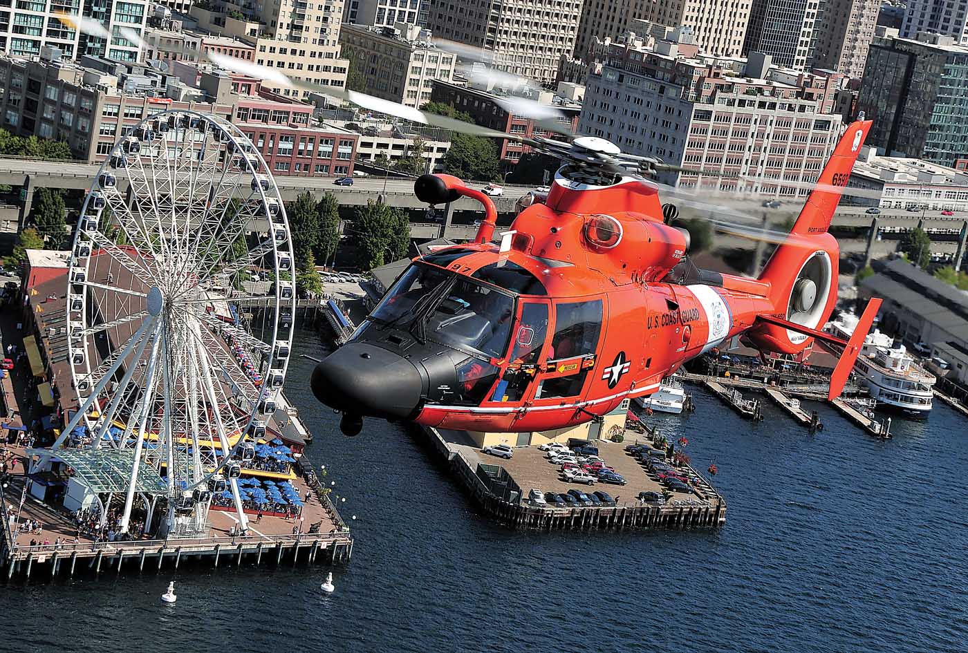 The operational area for U.S. Coast Guard Air Station Port Angeles includes Seattle’s waterfront and harbor facilities. Here, an Airbus MH-65D flies past Seattle’s Bay Pavilion. Skip Robinson Photo