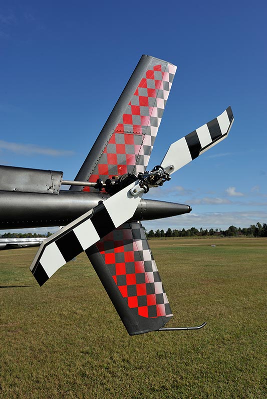 The blade design incorporates a non-symmetrical airfoil section and a swept tip.