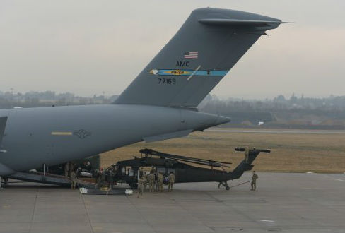 Soldiers from, 1st Battalion, 214th Aviation Regiment, remove a UH-60M model Black Hawk helicopter from an Air Force C-17 near Wiesbaden, Germany. Capt. Jaymon Bell Photo