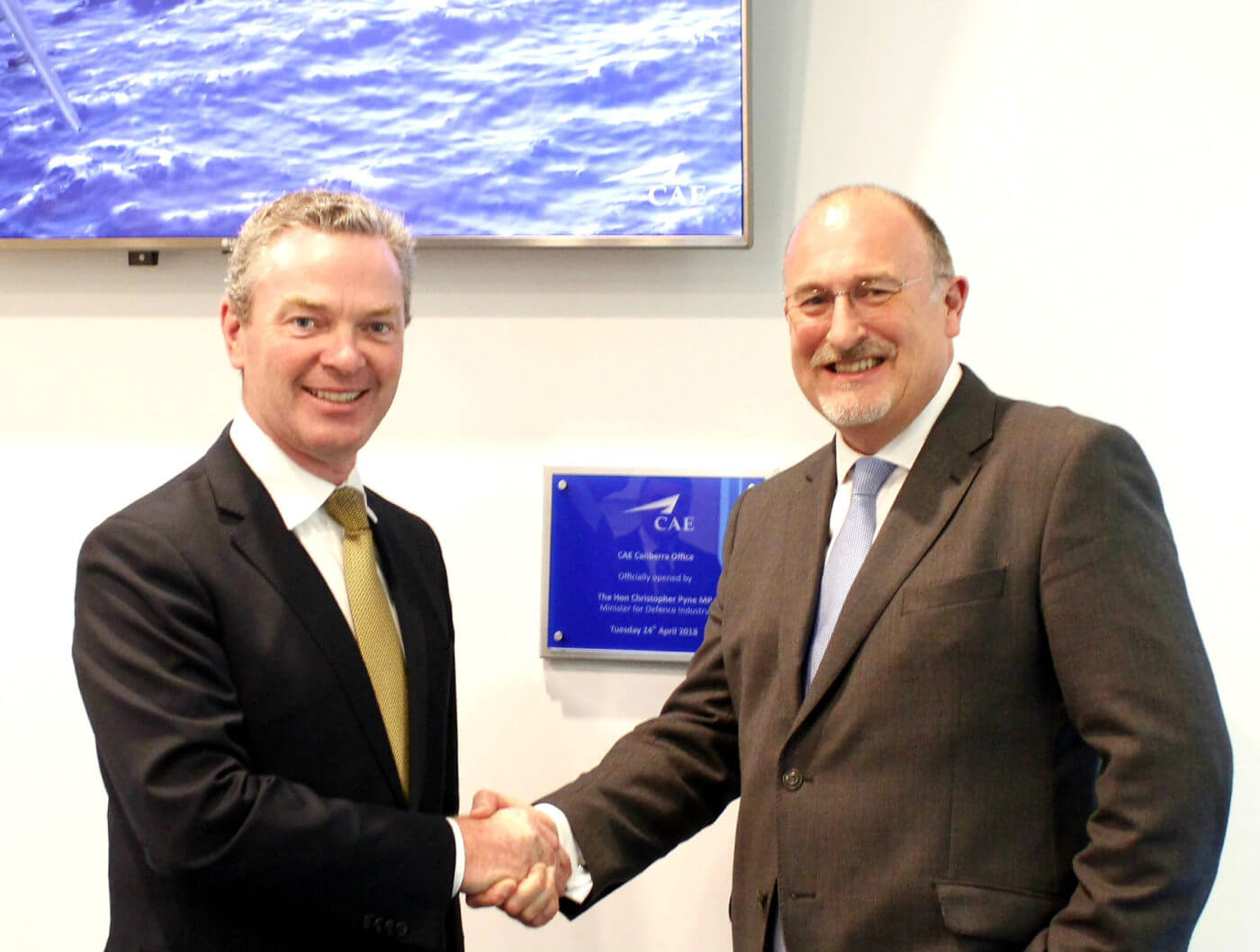 Australia's Minister for Defence Industry the Honorable Christopher Pyne (left) congratulates Ian Bell, CAE's vice president and general manager, Asia-Pacific/Middle East, on the opening of CAE's new office in Canberra. CAE Photo
