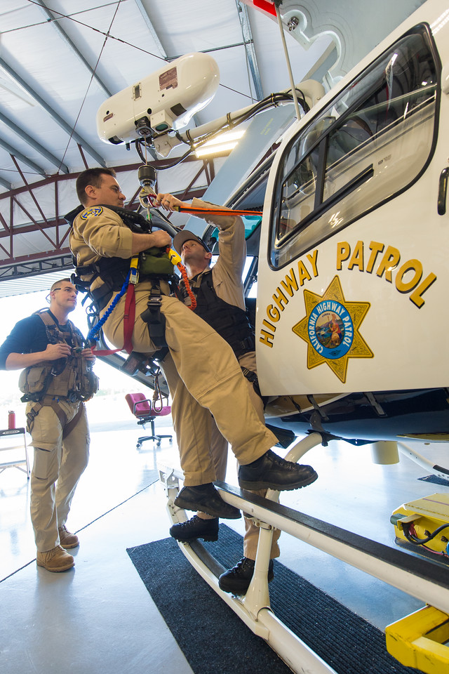 ARS instructor David Arias (left) looks on as officer Shaun Bouyea (on the hoist hook) and officer Brandon Hallam familiarize themselves with hoist hardware and procedures. Dan Megna Photo