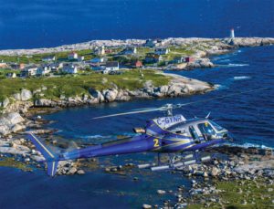 An Airbus H125 AStar, operated by Nova Scotia’s Department of Lands and Forestry, Aviation Services, flies alongside the popular fishing village of Peggy’s Cove in Nova Scotia. Mike Reyno Photo