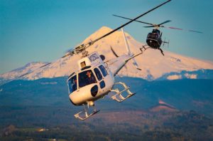 An Airbus H125 and Bell 407 operated by Hillsboro Aviation fly in front of Mount Hood in northern Oregon. Now celebrating 38 years in operation, the company continues to evolve alongside the industries it serves. Heath Moffatt Photo