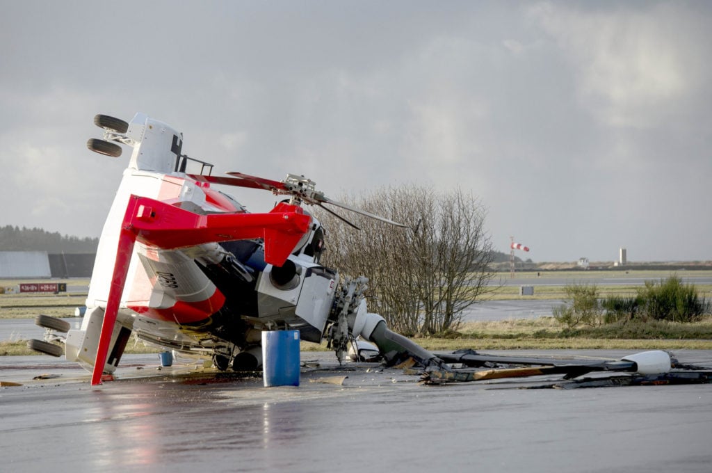 A Leonardo AW101 search-and-rescue helicopter owned by the Royal Norwegian Air Force rests on its side after a failed ground run on Sola Airport near Stavanger, Norway, Nov. 25, 2017.