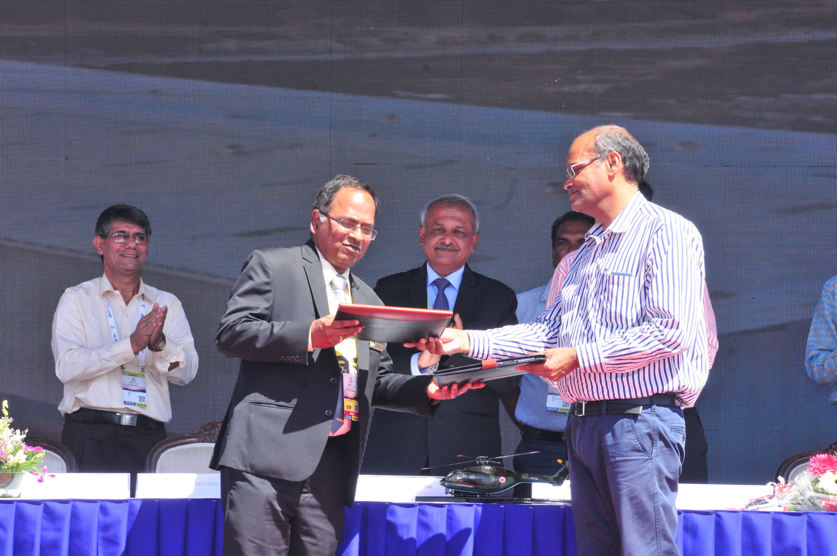 Representatives from HAL and CPWD celebrate the signing of the memorandum of understanding at Aero India 2019. HAL Photo
