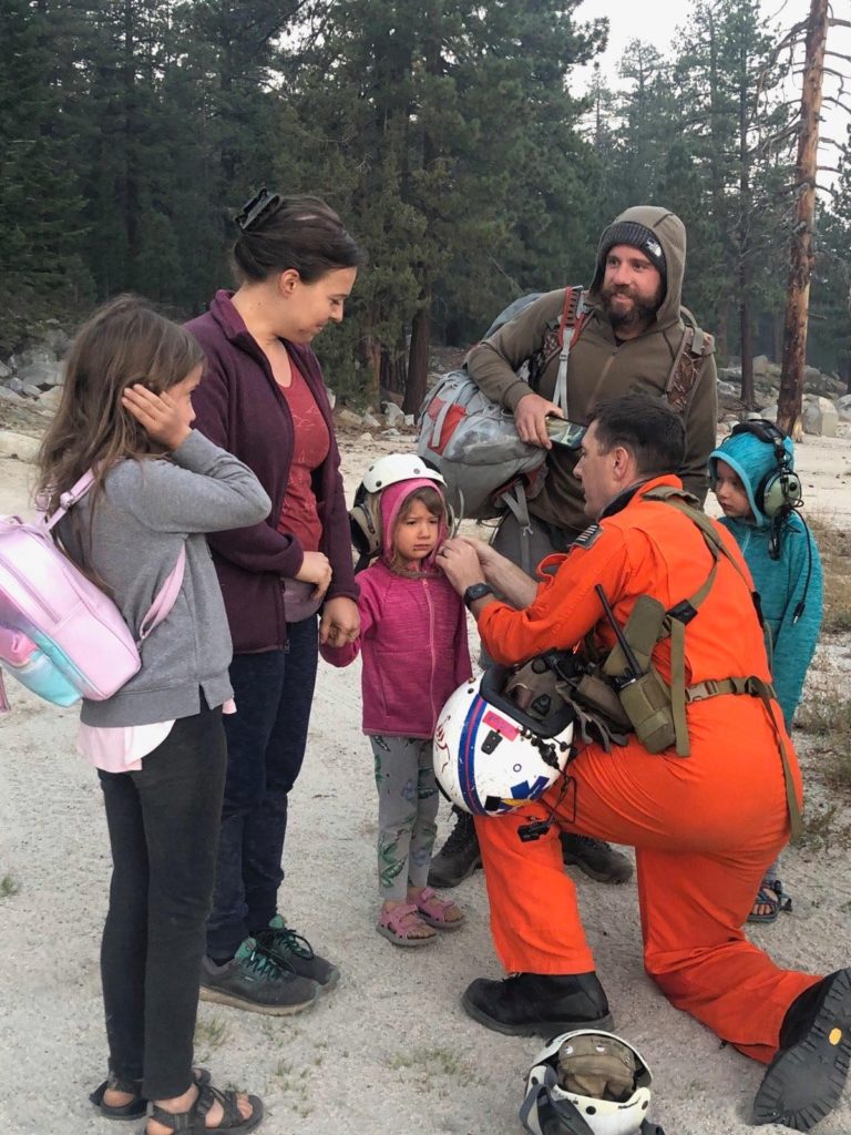 Leemore SAR Hospital Corpsman First Class Tyler Hodge prepares a family for evacuation.