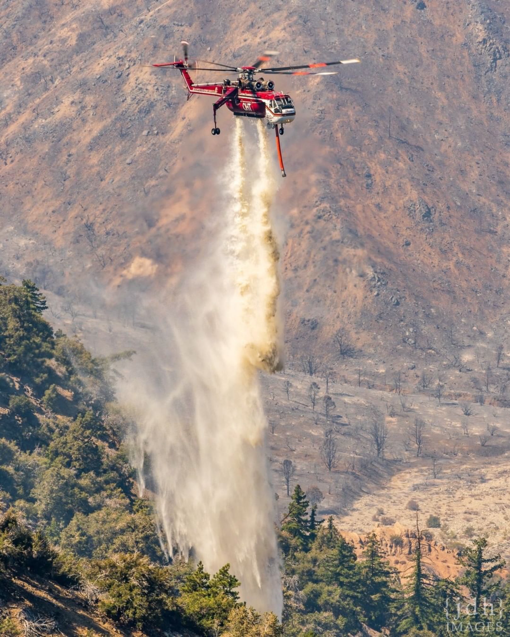A Sikorsky CH-54B from Helicopter Transport Services douses a hotspot on the Bobcat Fire in California. Photo submitted by Instagram user @jdhimg using #verticalmag