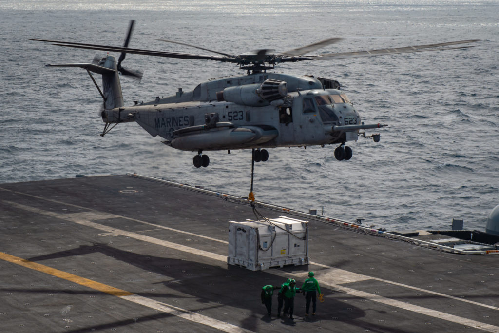 A U.S. Marine Corps CH-53 Sea Stallion takes a mock F135 engine power module from the USS Carl Vinson carrier back to the USNS Richard E. Byrd supply ship in March during a vertical replenishment-at-sea (VERTREP). 
