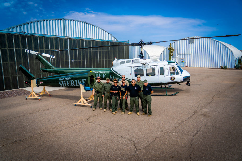 The Pinal County Sheriff’s Office support and operations team stands alongside the new UH-1H tailboom at their facility in Arizona. PCSO Photo