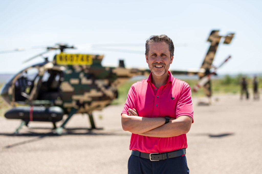 Alan Carr, sole director of MD Helicopters, in front of a Malaysian MD 530G at a gunnery range in West Texas. Billy Hardiman Photo