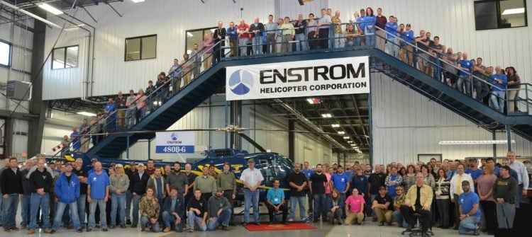 Enstrom employees pose alongside an Enstrom 480B at the company's factory in Menominee, Michigan. Enstrom Helicopter Photo