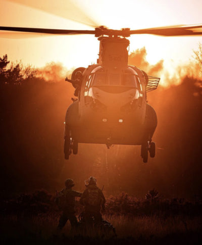 A Royal Netherlands Air Force Boeing CH-47F Chinook practices sling load operations as the sun sets. Photo submitted by Instagram user @matthijsvanosphotography using #verticalmag