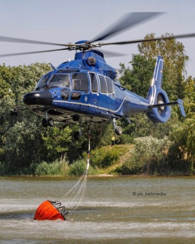 Airbus Helicopters EC155 B1 from the German Federal Police filling a Bambi bucket with water from a small lake to fight a large forest fire in Treuenbrietzen, south of Berlin. Photo submitted by Instagram user @pb_helimedia