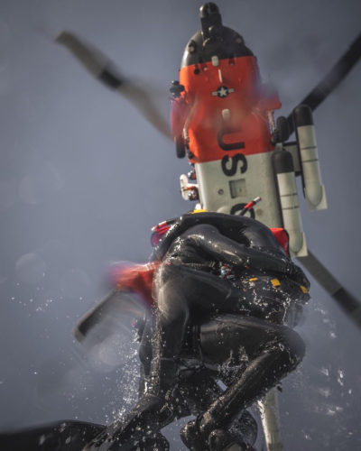 U.S. Coast Guard rescue swimmers practice being hoisted up from the ocean to a hovering MH-60 Jayhawk. From Instagram user 646_photography
