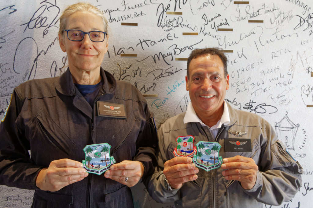 Martine Rothblatt and Ric Webb stand in front of the "Hero Wall" that they signed at Atlantic Aviation FBO after their arrival at Palm Springs Airport. Timothy Wheeler Photo