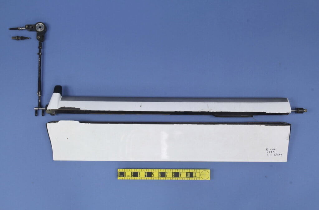 Investigators determined this servo flap from the Central Copters K-Max’s left rotor system failed prior to the collision between the rotor systems. NTSB Photo