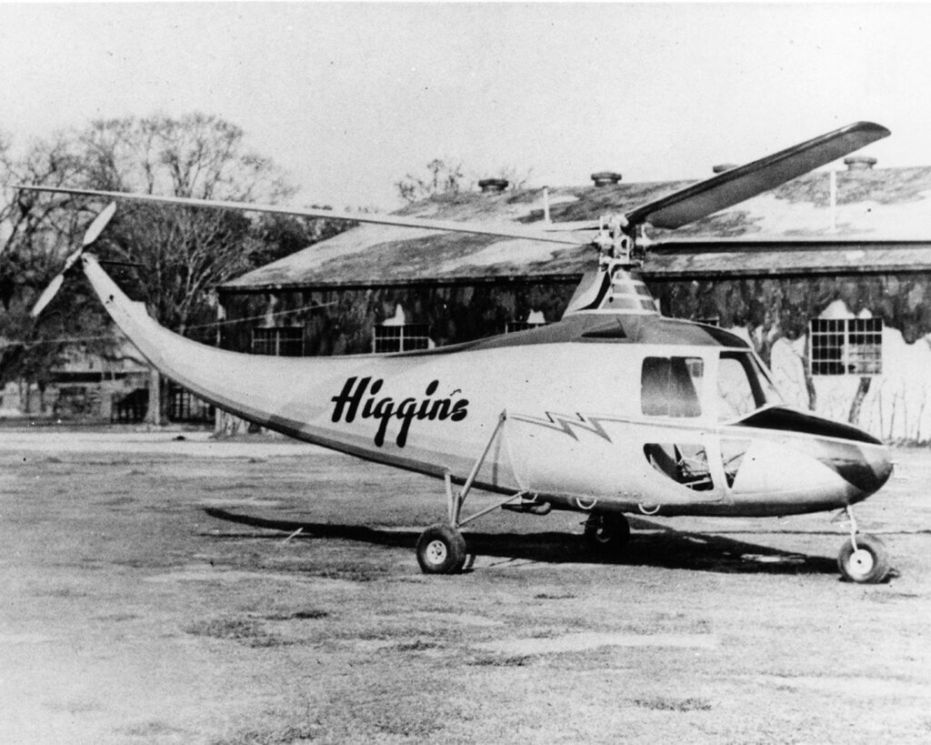 A Higgins EB-1 helicopter rests on the ground.