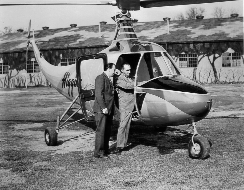 Enea Bossi (right), designer of the Higgins helicopter, shows his son the cockpit layout in the Higgins EB-1. 