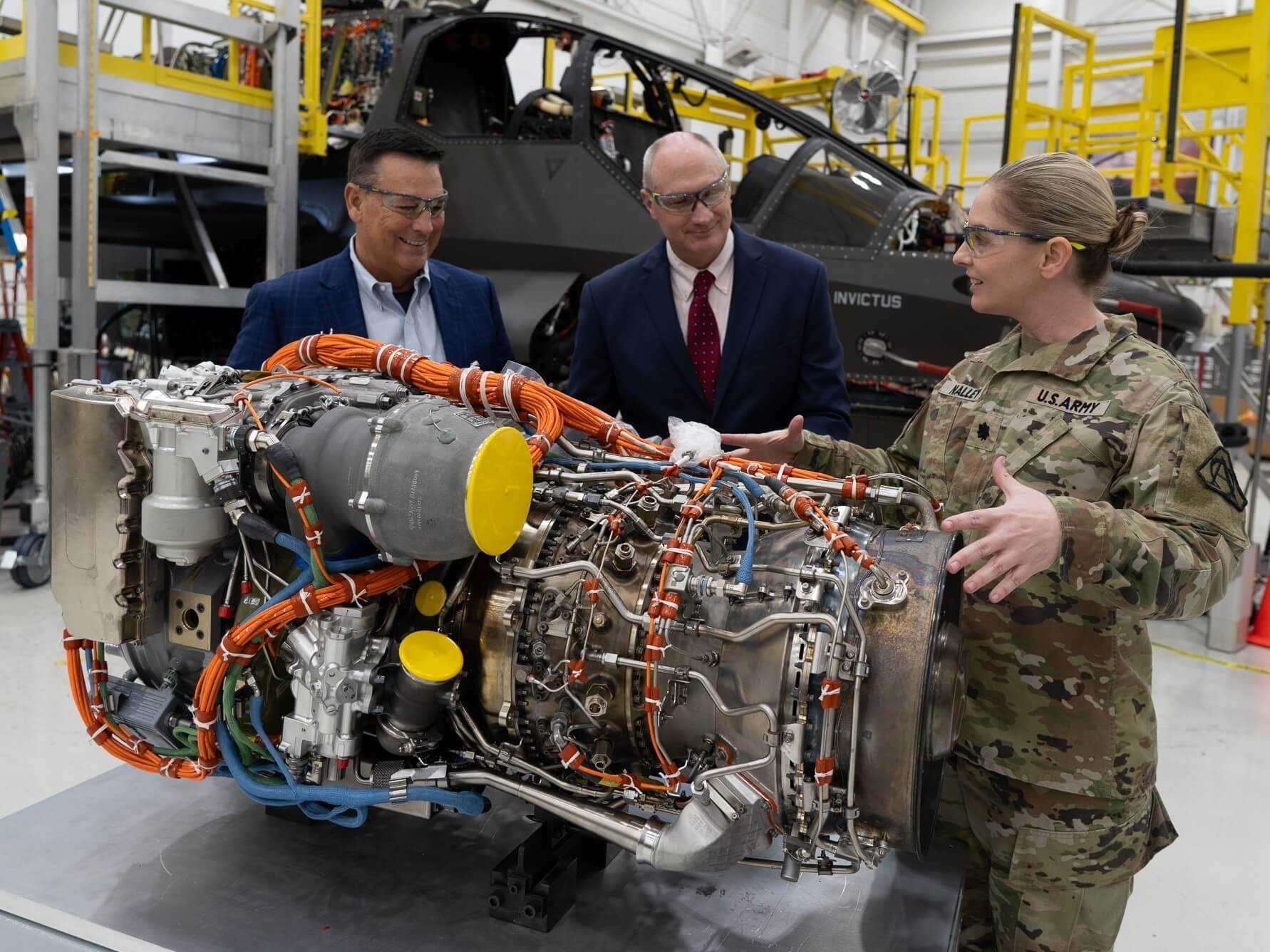 Lt. Col. Kelley Nalley, the Improved Turbine Engine Product Manager (right) discusses the recently delivered T901 engine with Bell senior vice president Chris Gehler (left), and Richard Crabtree, PM Future Attack Reconnaissance Aircraft program integrator. The Army delivered the T901 Improved Turbine Engine to Bell’s Fort Worth, Texas, plant on Oct. 20. U.S. Army Photo